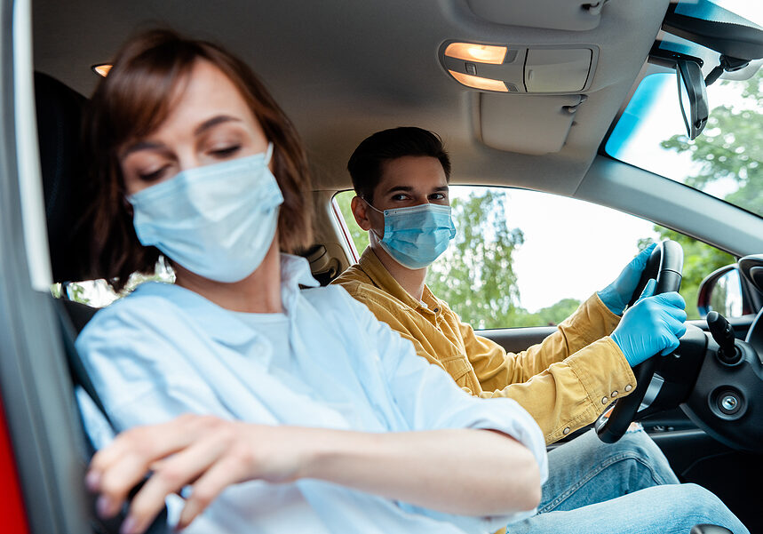 and woman in medical masks and protection gloves sitting in car during coronavirus pandemic, selective focus