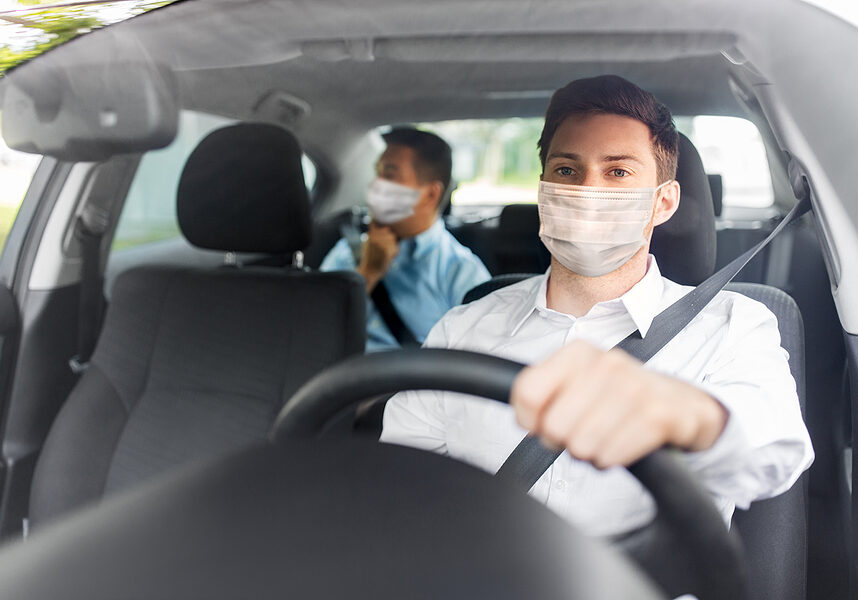 health protection, safety and pandemic concept - male taxi driver wearing face protective medical mask driving car with passenger