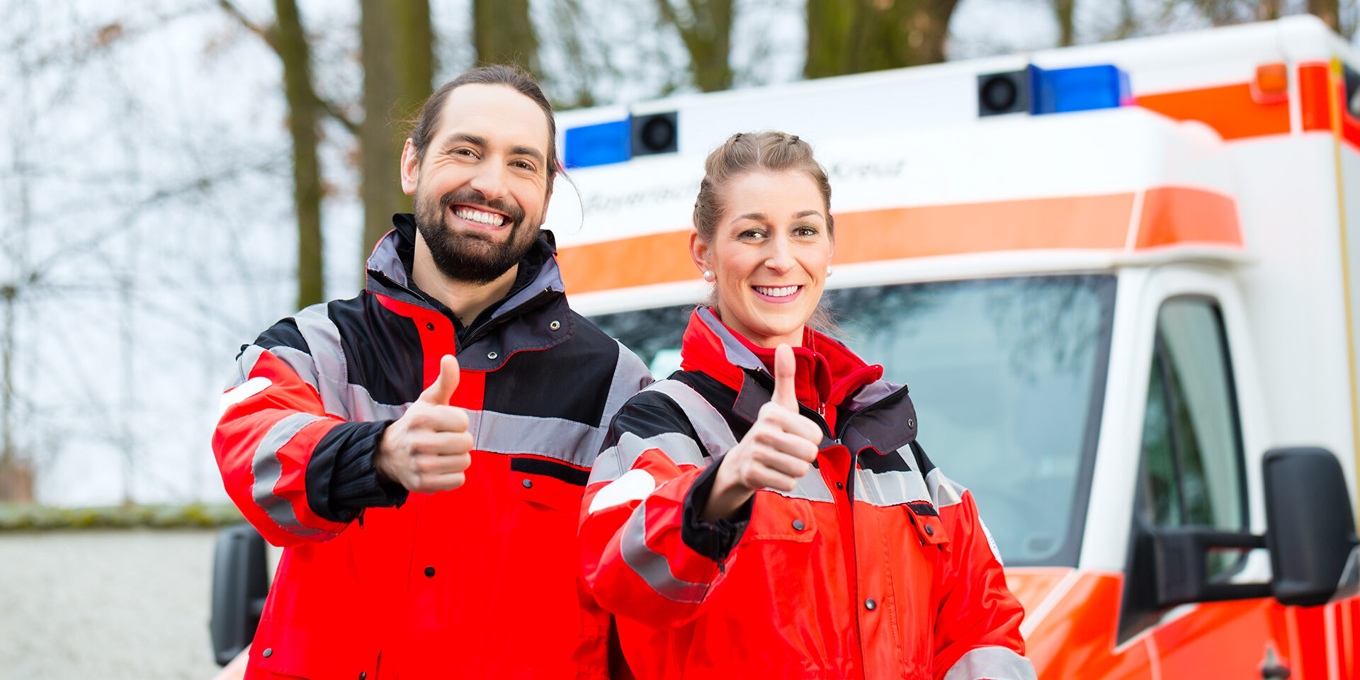 Emergency doctor and nurse standing in front of ambulance