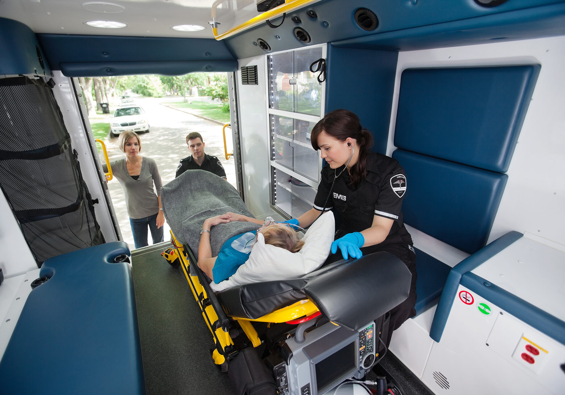 Elderly woman loaded in ambulance being given oxygen